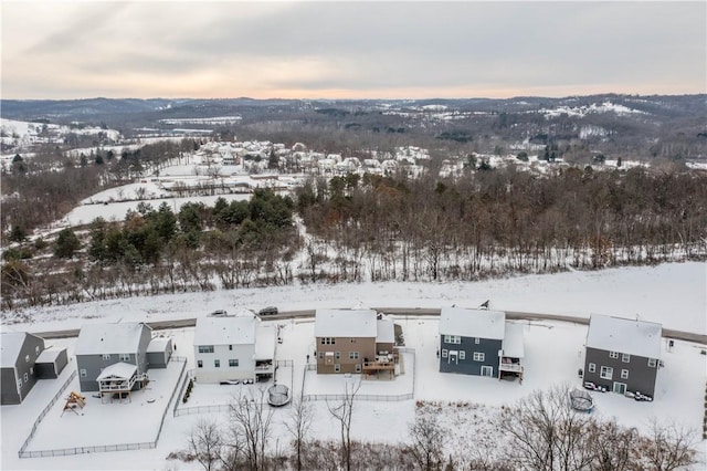 snowy aerial view featuring a mountain view