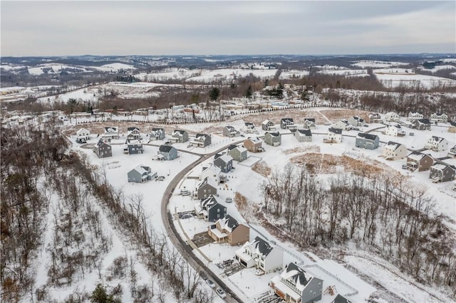 snowy aerial view with a residential view