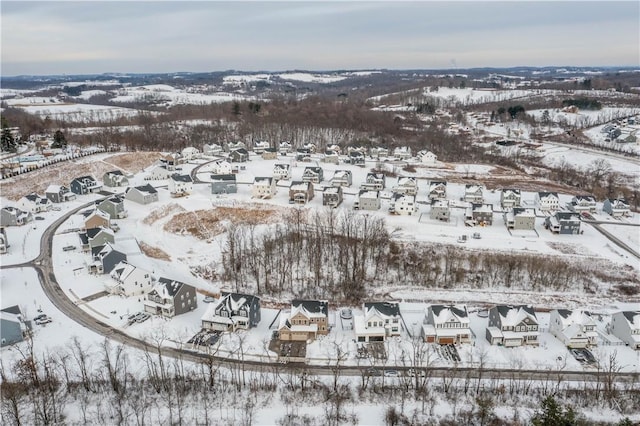 snowy aerial view with a residential view