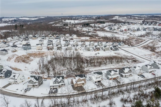 snowy aerial view featuring a residential view