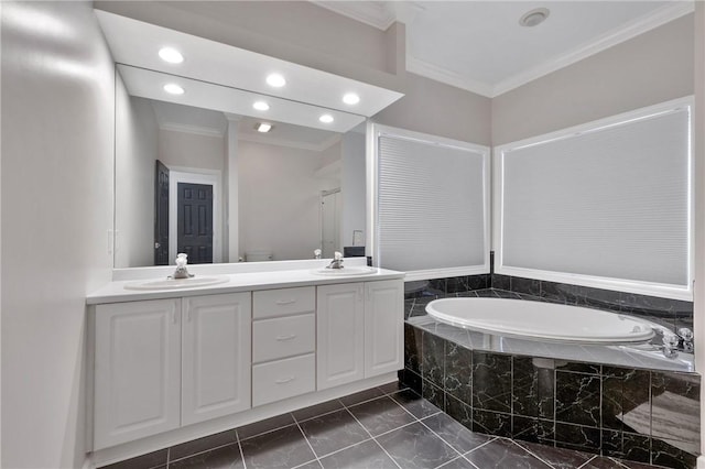 bathroom with vanity, tiled tub, and ornamental molding