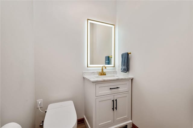 bathroom featuring vanity and toilet