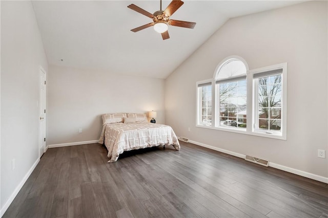 unfurnished bedroom featuring lofted ceiling, dark hardwood / wood-style floors, and ceiling fan