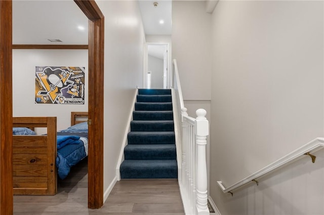 staircase with wood-type flooring