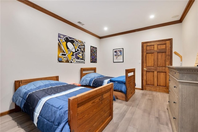 bedroom with ornamental molding and light wood-type flooring