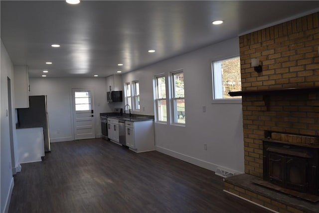 kitchen featuring white cabinetry, stainless steel appliances, dark hardwood / wood-style flooring, and sink