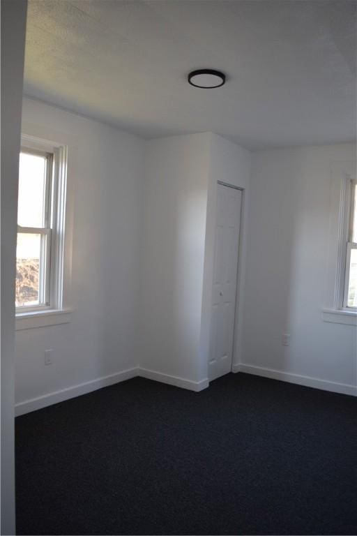 carpeted spare room with a healthy amount of sunlight