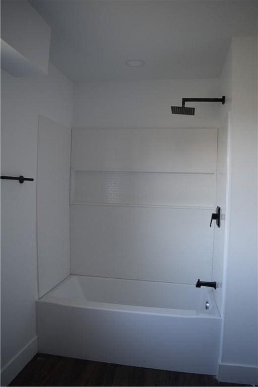 bathroom featuring wood-type flooring and  shower combination