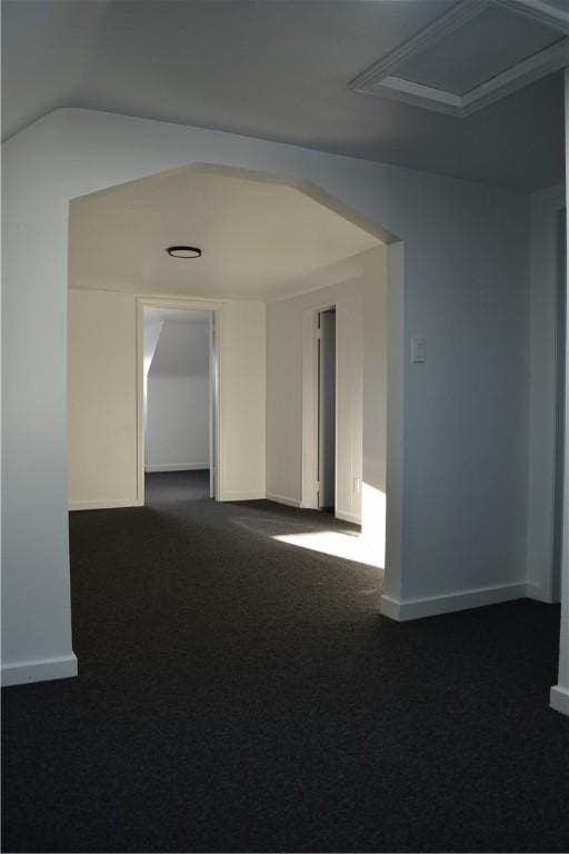 carpeted empty room featuring lofted ceiling