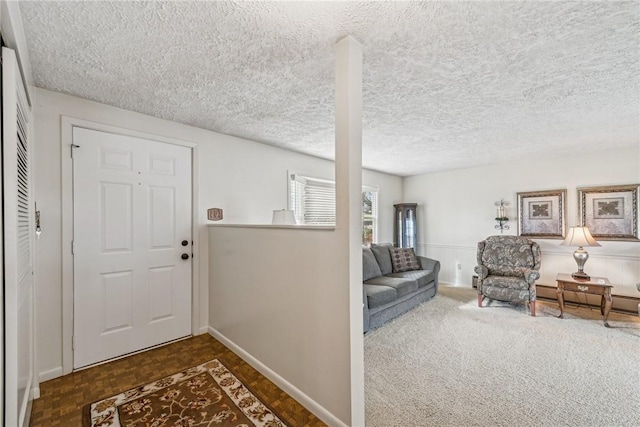 interior space with a baseboard heating unit, dark parquet floors, and a textured ceiling