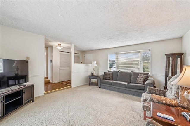 carpeted living room featuring a textured ceiling