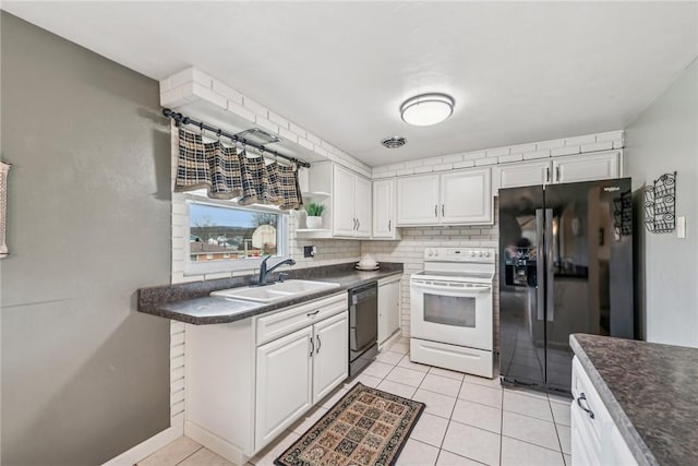 kitchen with light tile patterned flooring, sink, white cabinets, decorative backsplash, and black appliances