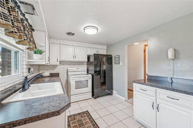 kitchen featuring sink, white cabinets, white range with electric stovetop, and black refrigerator with ice dispenser