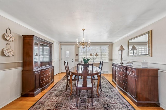 dining room with a notable chandelier and light hardwood / wood-style floors