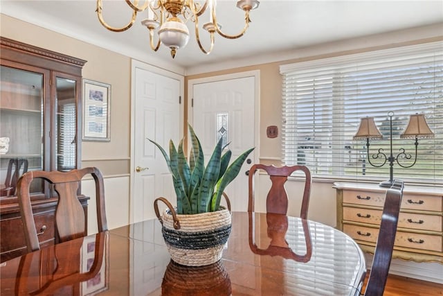 dining area featuring an inviting chandelier and light hardwood / wood-style floors