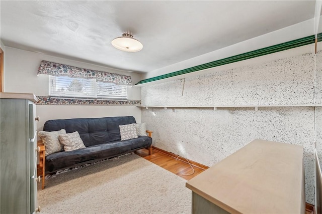 sitting room with wood-type flooring