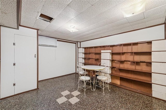 unfurnished dining area featuring a wall mounted AC