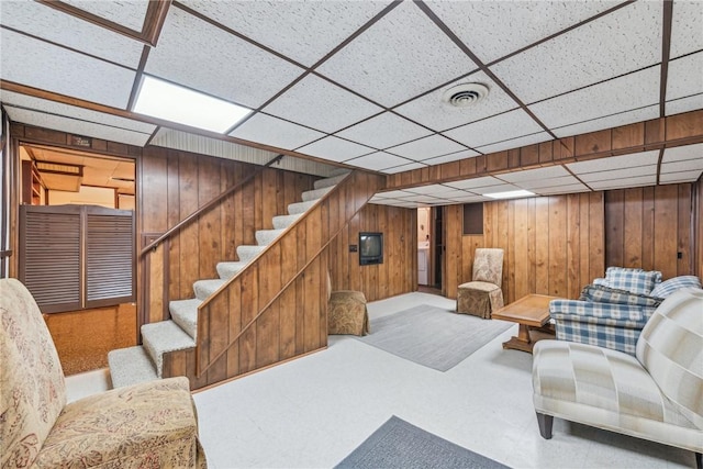 interior space with carpet floors and wooden walls