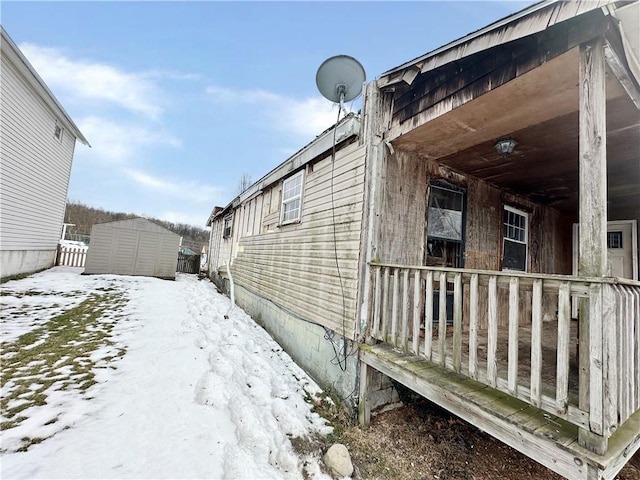 view of snow covered exterior featuring covered porch