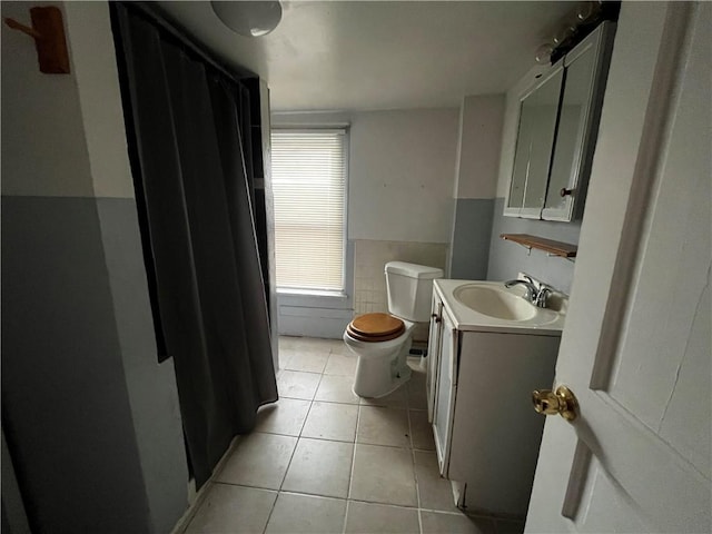 bathroom with tile patterned floors, toilet, and vanity