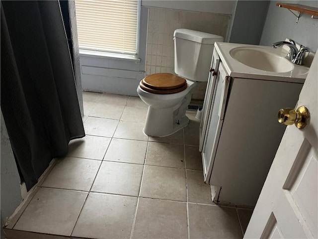 bathroom featuring tile patterned flooring, vanity, and toilet