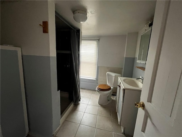 bathroom featuring vanity, tile patterned floors, and toilet