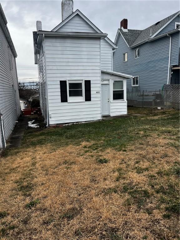 back of property with a yard