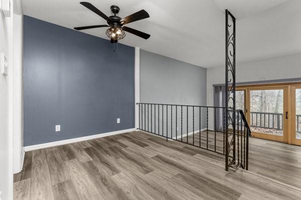 empty room featuring ceiling fan and hardwood / wood-style floors