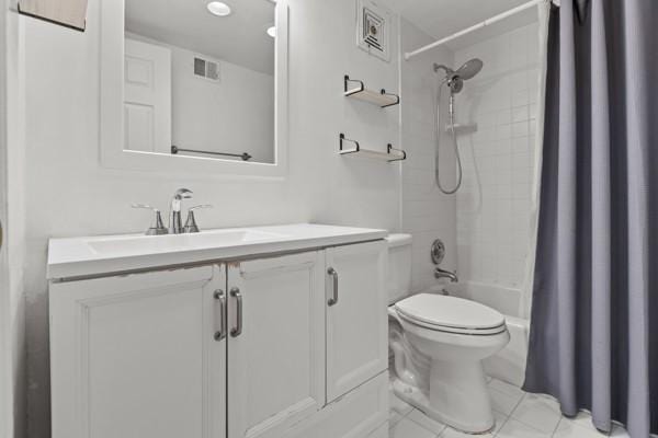 full bathroom featuring vanity, shower / bath combo, and toilet