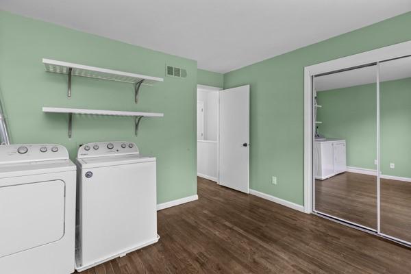 laundry room featuring dark wood-type flooring and washing machine and dryer