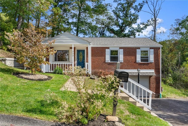 view of front of property featuring a porch, a garage, and a front yard