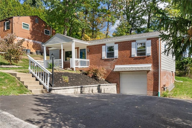 view of front of property featuring a garage and a porch