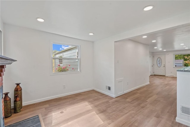 unfurnished living room with light hardwood / wood-style flooring