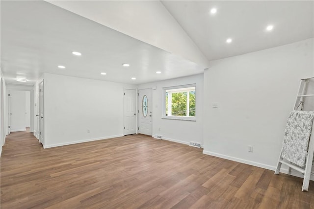 interior space with hardwood / wood-style flooring and lofted ceiling