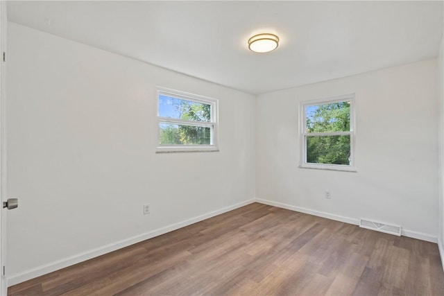 spare room featuring hardwood / wood-style floors