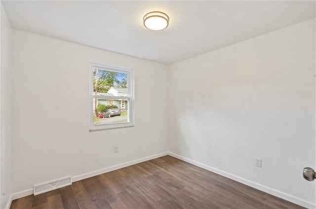 empty room featuring dark hardwood / wood-style flooring