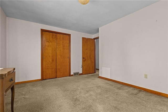 unfurnished bedroom with carpet floors and a closet