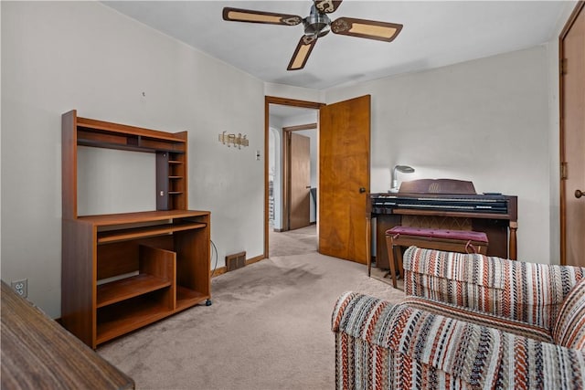 sitting room featuring ceiling fan and light colored carpet