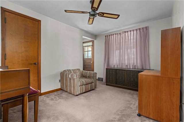 sitting room featuring light carpet and ceiling fan