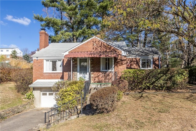 view of front of property with a garage and a front lawn