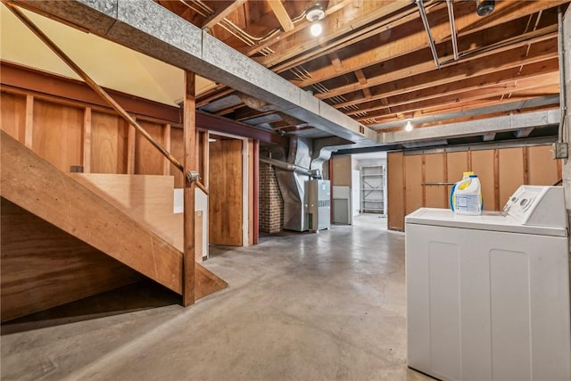 basement with heating unit and washing machine and clothes dryer