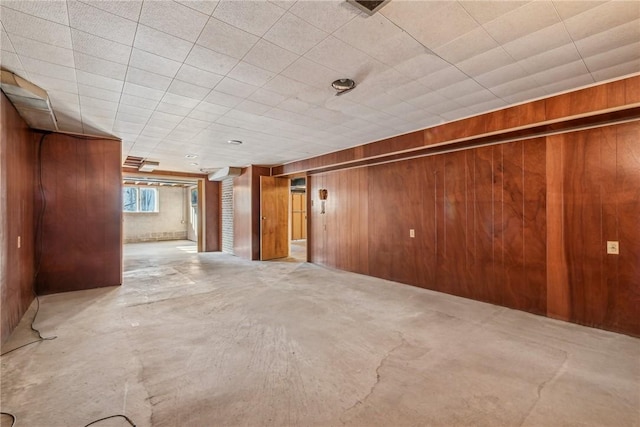 spare room featuring wood walls