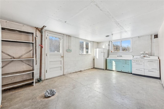 interior space featuring sink and white fridge