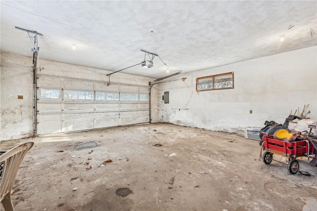 garage with a garage door opener and electric panel