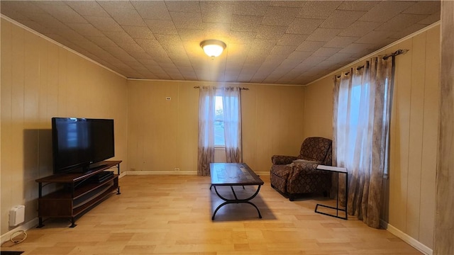 living area with ornamental molding and light wood-type flooring