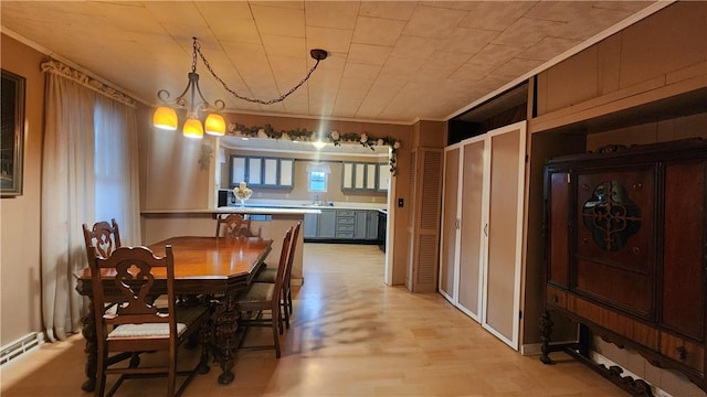 dining area with a notable chandelier and light hardwood / wood-style floors