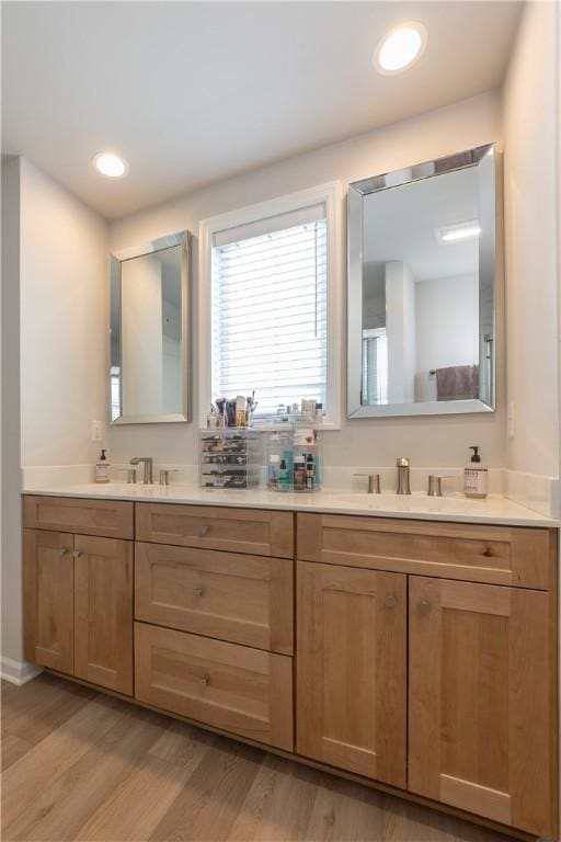 bathroom featuring hardwood / wood-style flooring and vanity