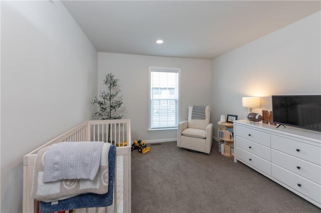 carpeted bedroom with a nursery area