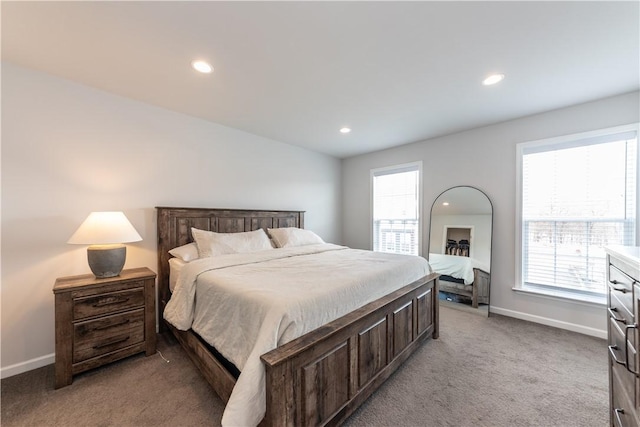 carpeted bedroom featuring multiple windows