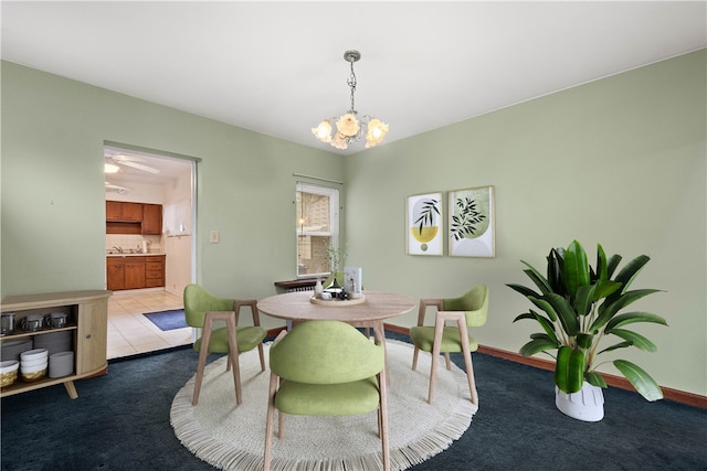 carpeted dining area with sink and a notable chandelier